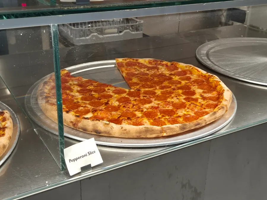 Mushroom pizza visible in the showcase