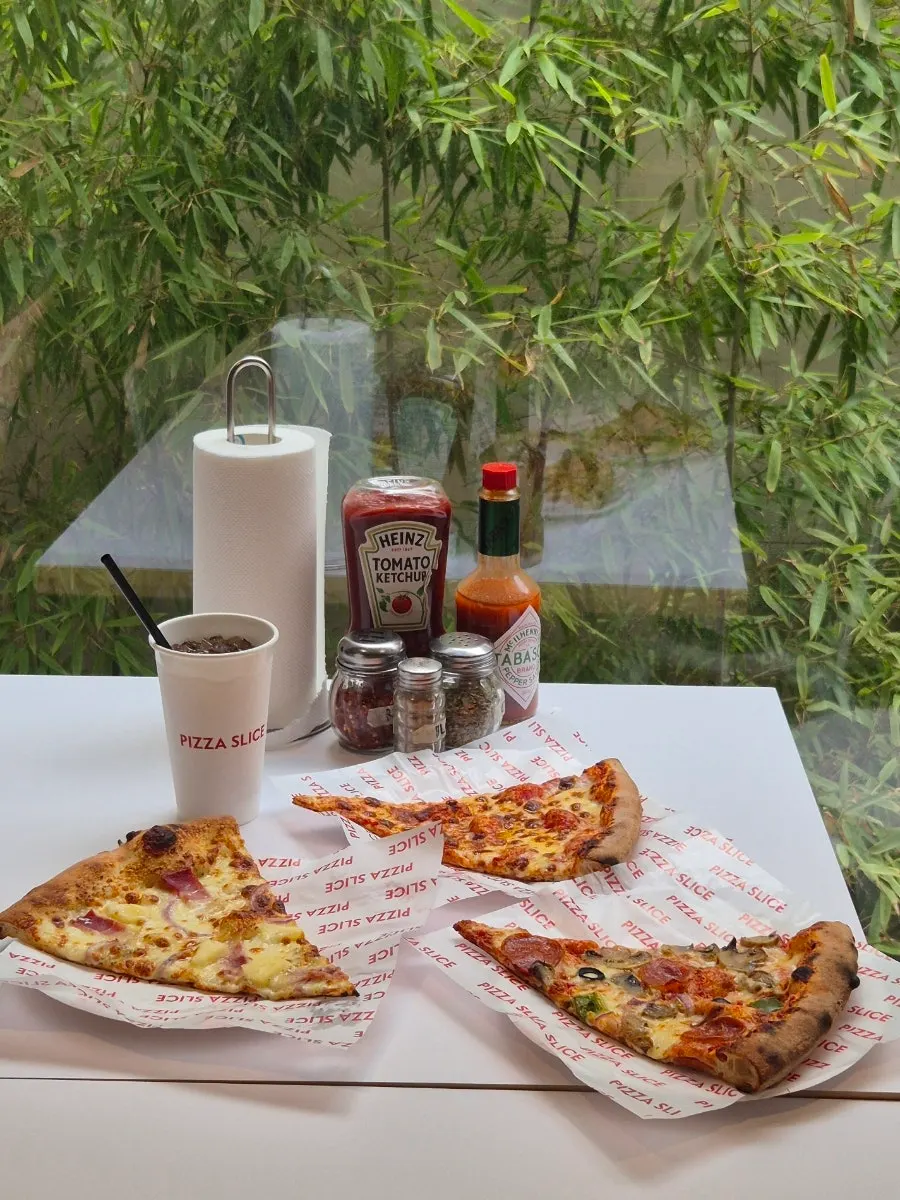 Table set with hot sauce, ketchup, and pepper