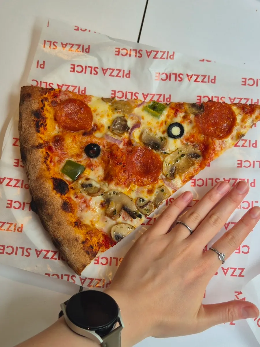 A generously sized slice pizza on the table