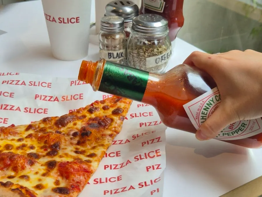 Cheese slice topped with tomato sauce and cheese