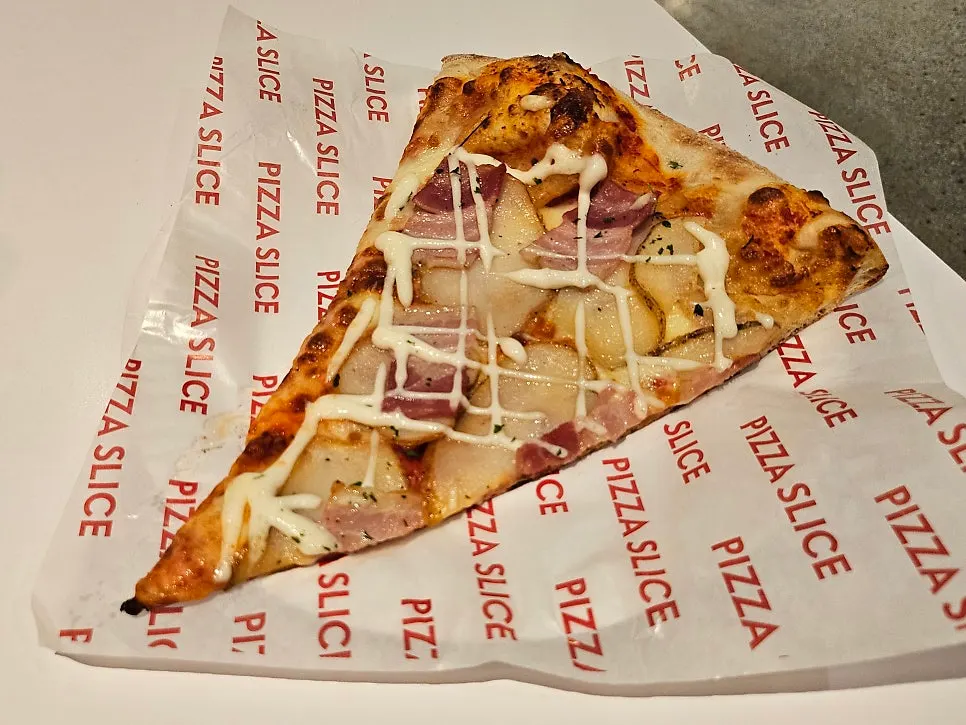Potato pizza slice topped with thinly sliced potatoes