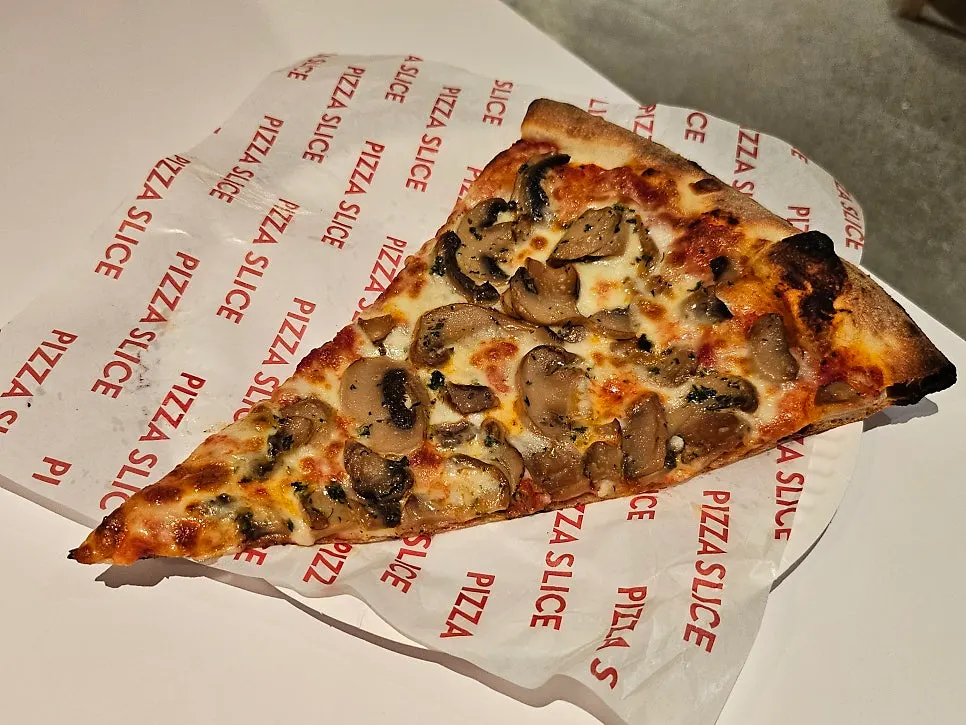 Potato pizza slice being lifted up