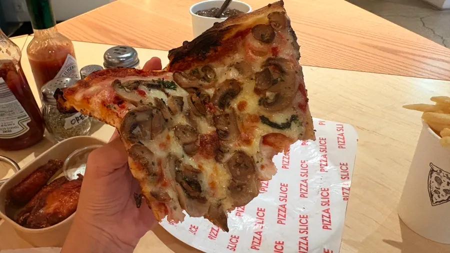 Cross-section of the mushroom pizza piled with mushrooms