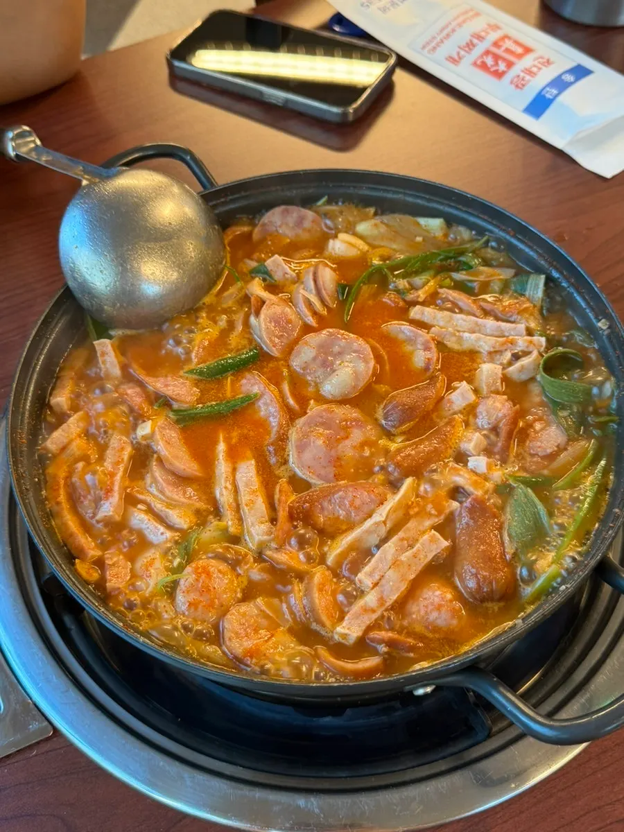 Pot of Songtan-style budae jjigae starting to boil