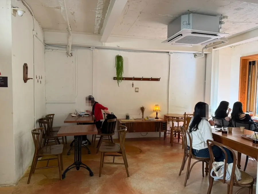 Sunlit second floor of 5to7 with a window wall