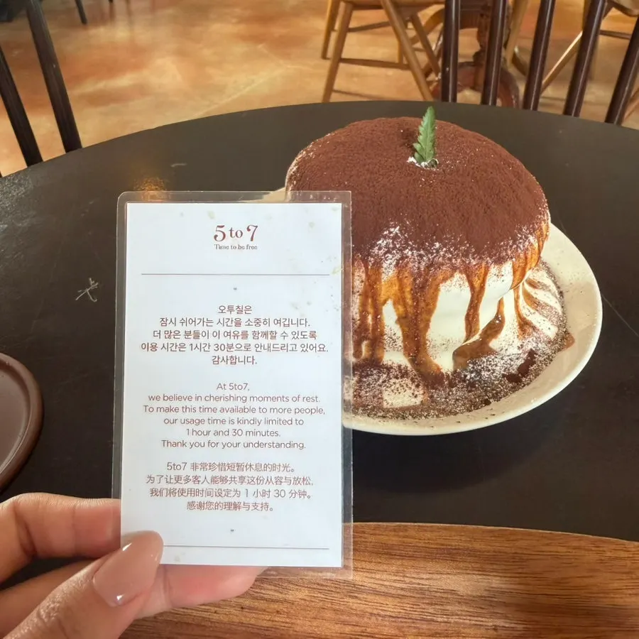 Tiramisu soufflé topped with cocoa powder and cream