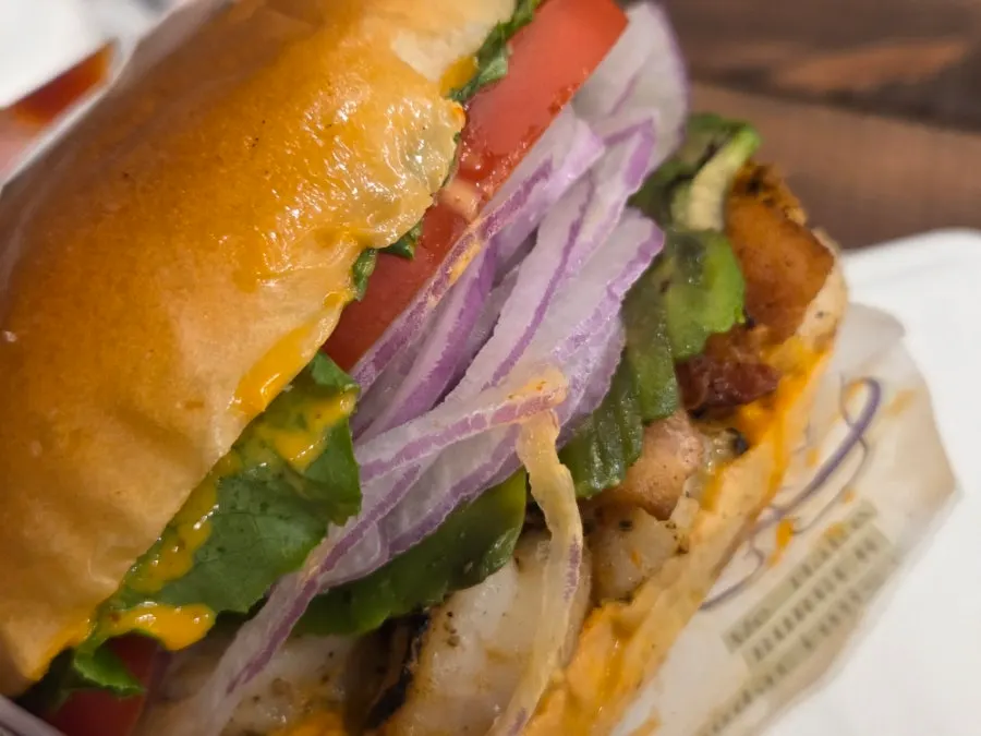 Taking a bite of the whole shrimp burger