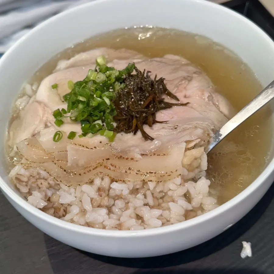 Multigrain rice visible inside the clear broth