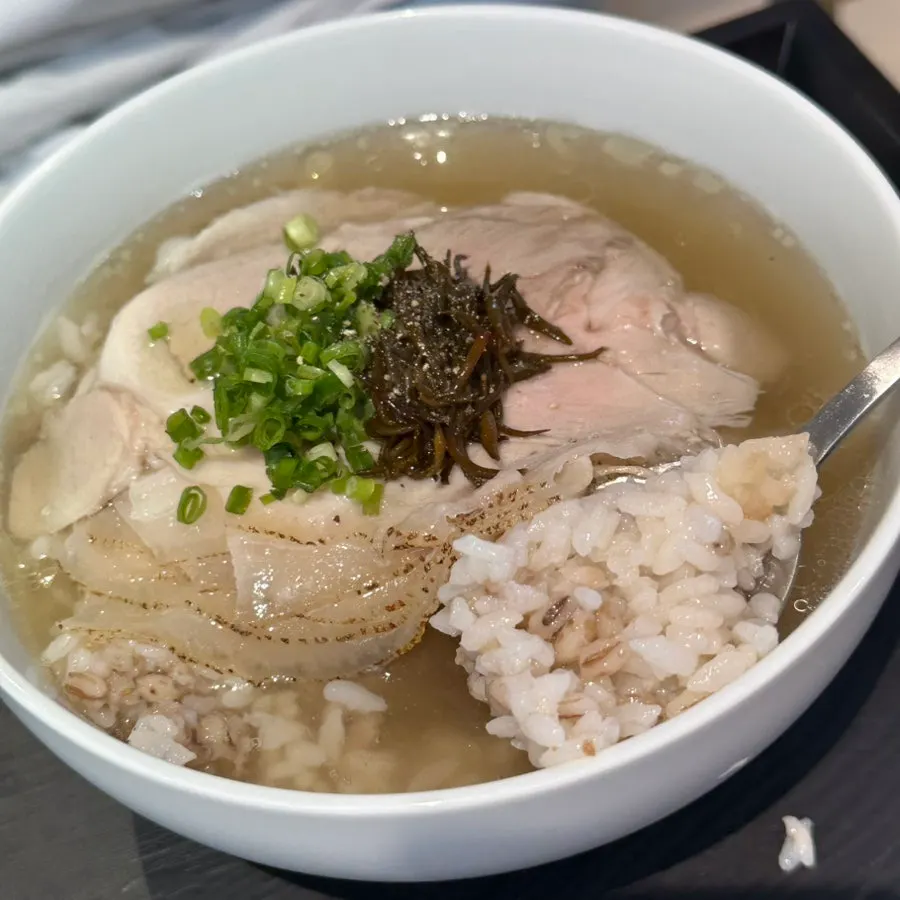 A spoonful of clear gomtang broth and rice