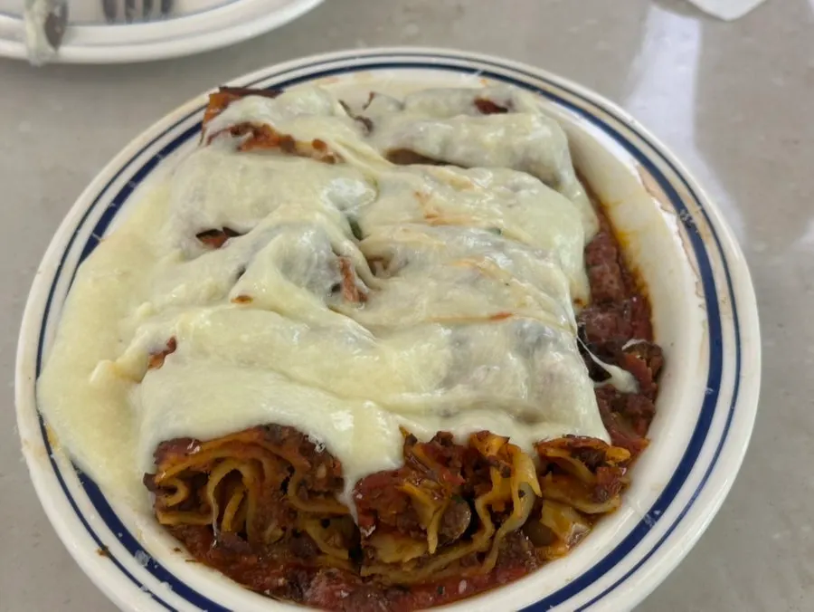 Wide shot of the steaming cheese lasagna