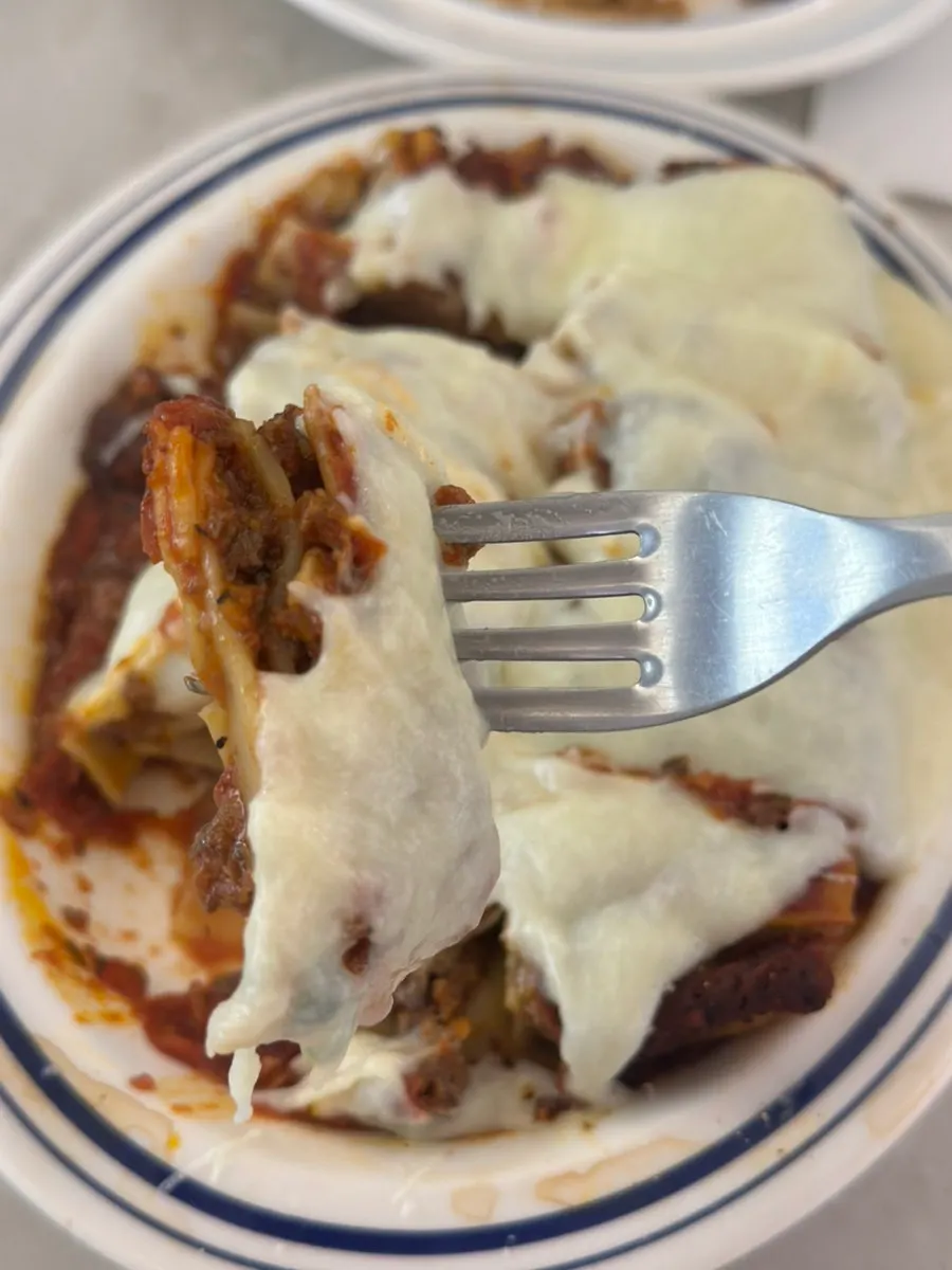 A slice of lasagna showing layered fresh pasta