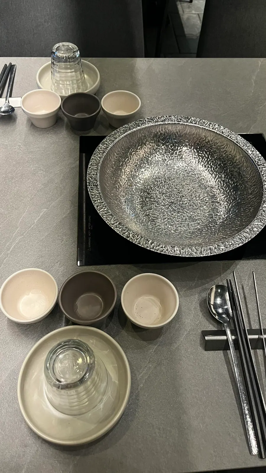 Chopsticks and plates set up at the table at Shabu in Seoul Seongsu
