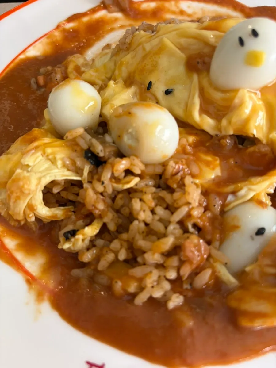 Inside the omurice showing salmon and vegetable fried rice
