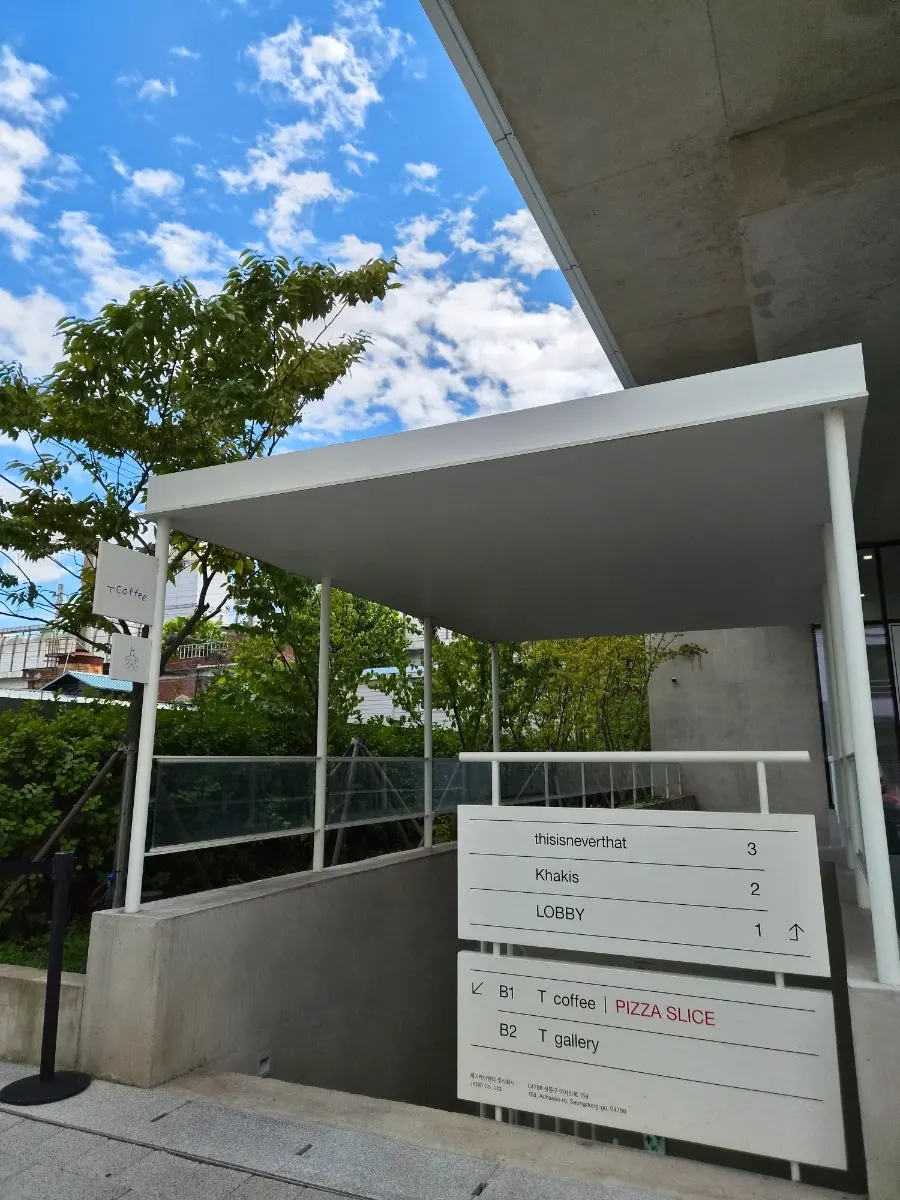 Sign in front of the building where T Coffee is located, with the basement entrance