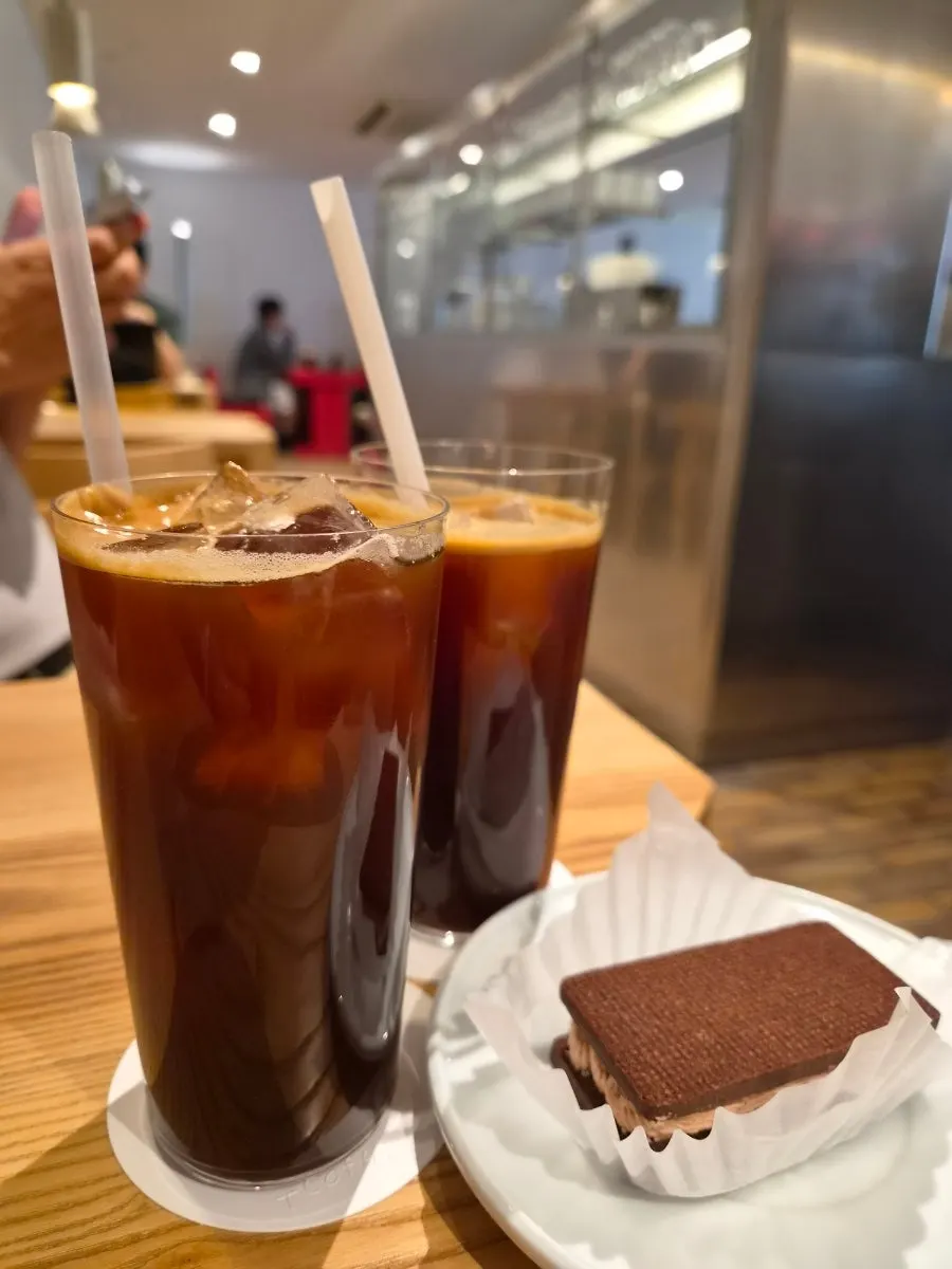 Table setting with two Americanos and a choco sand cookie