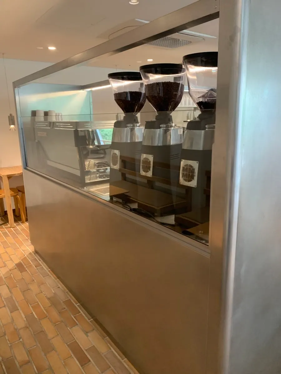 Silver coffee bar and surrounding wood furniture