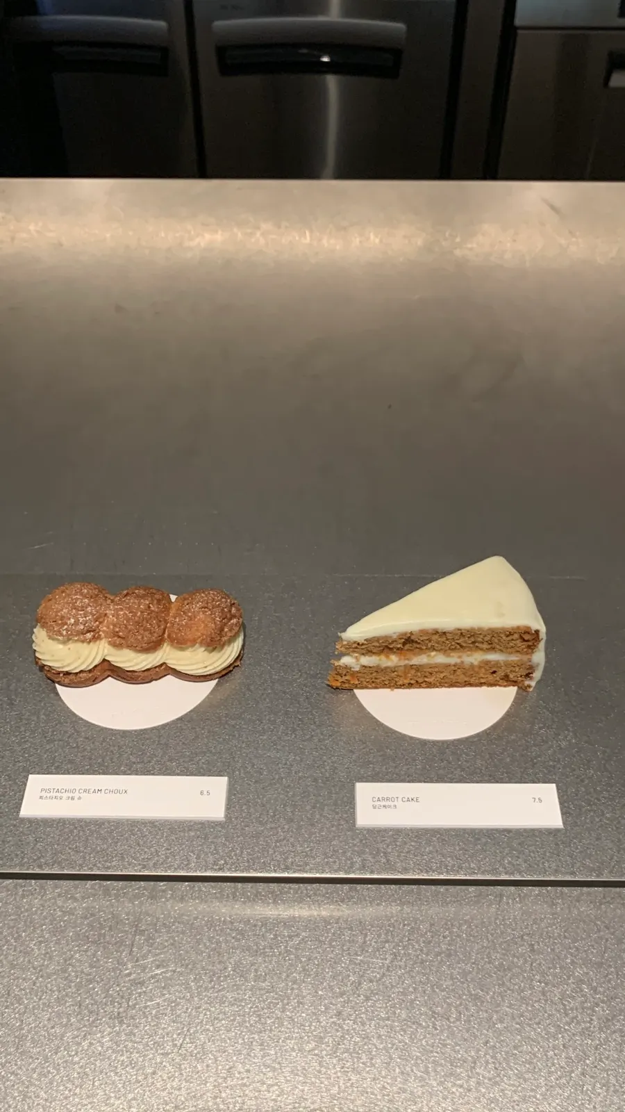 Pistachio cream puff and cake on display