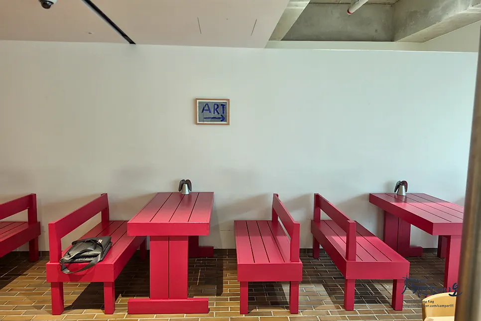 Seating at T Coffee with greenery visible through the window
