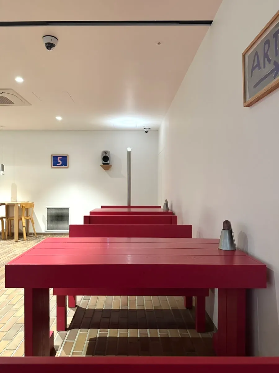 Brick tile floor with wall art and speakers