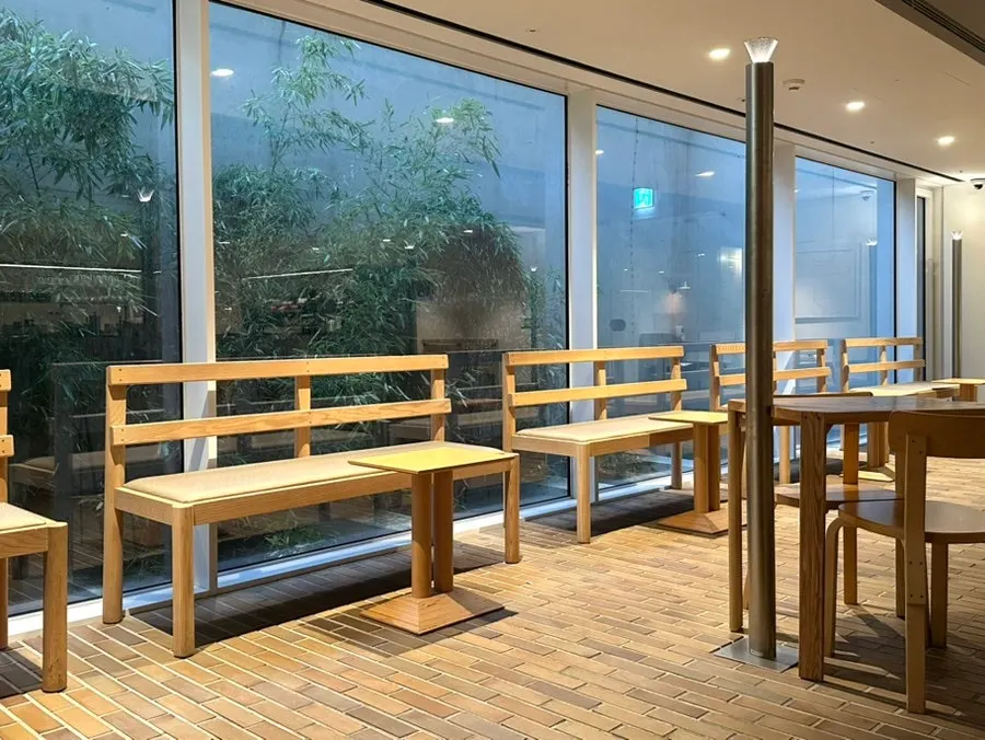 Window seat with a green view through large glass panes