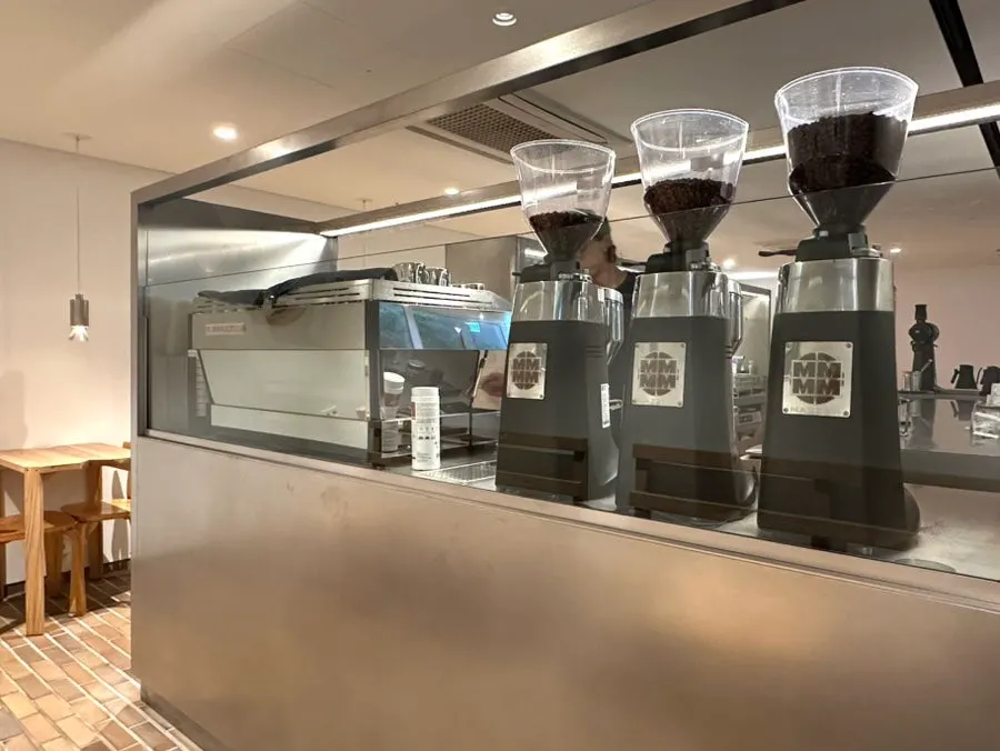 Neatly arranged coffee machine and grinder at the open bar