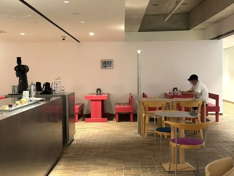 Full view of the café interior mixing red and wood tones