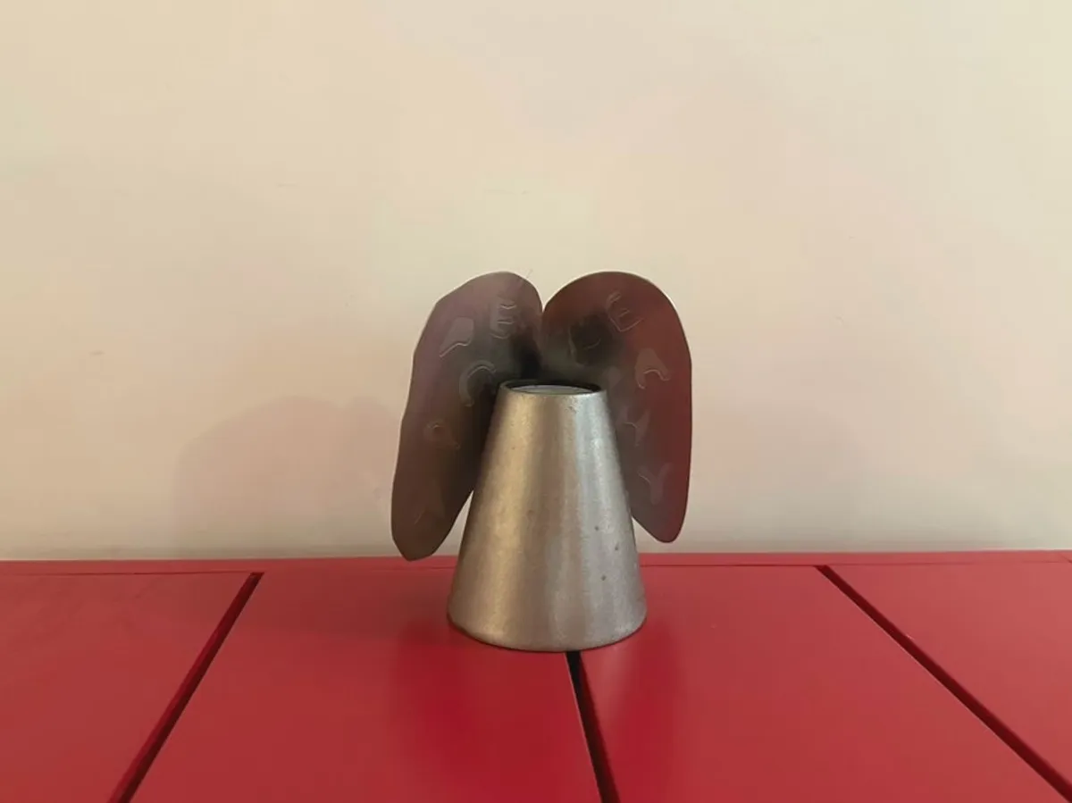 A uniquely designed candlestick on a red table
