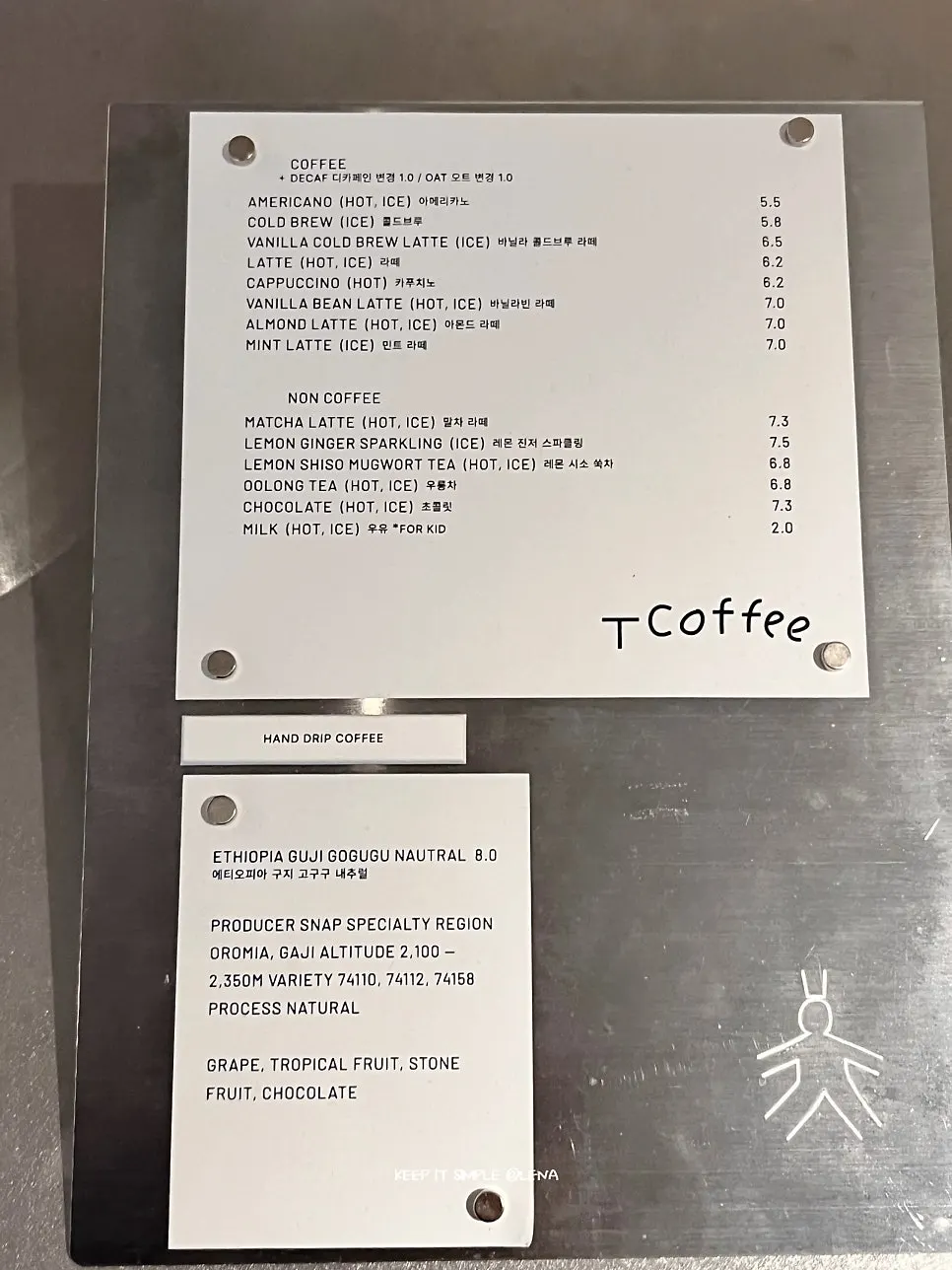 T Coffee's menu board listing americanos and hand drip
