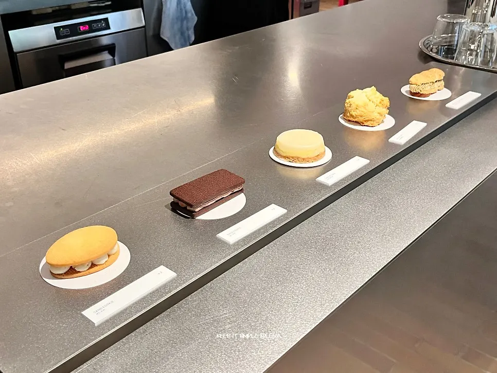 Small desserts on display, including sandwiches and biscuits