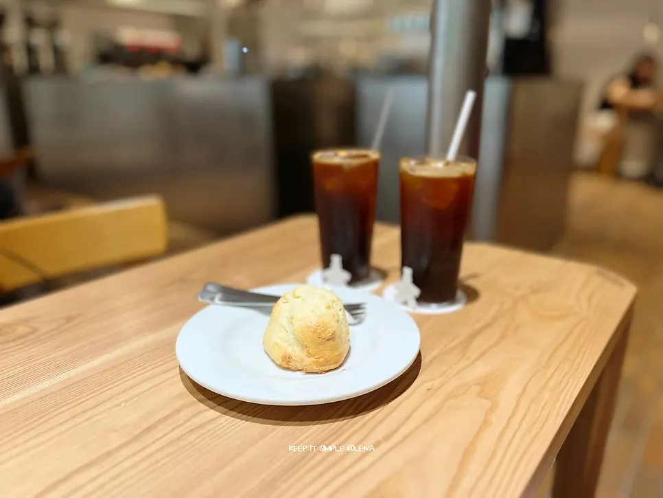 Table with two americanos and the biscuit