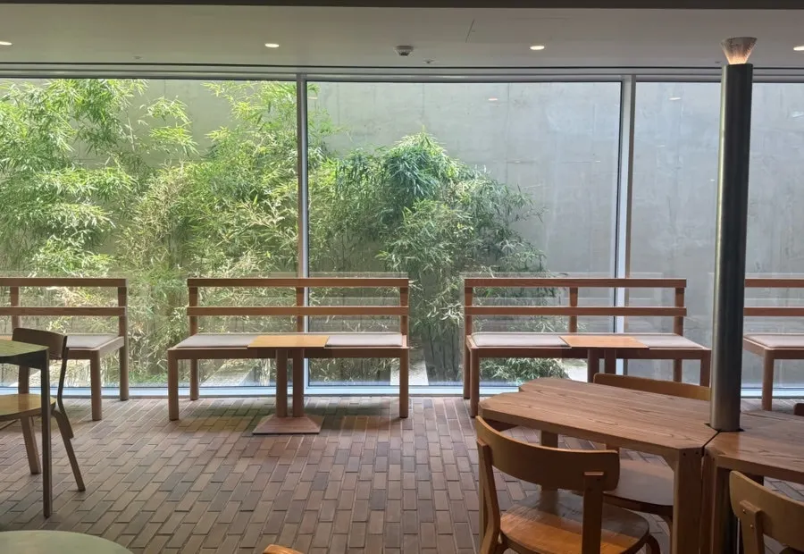 Basement café interior lit by floor-to-ceiling windows