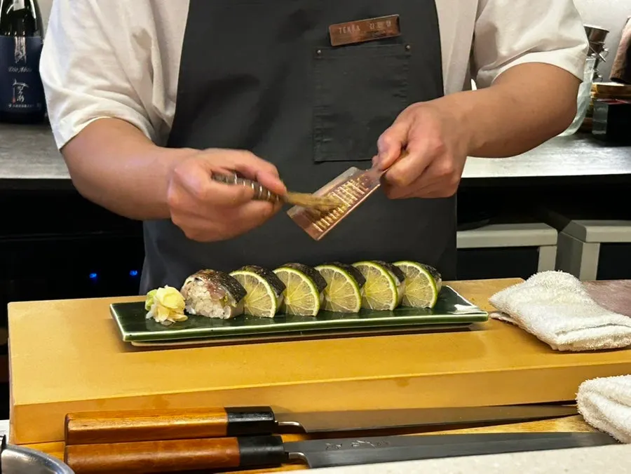 Torch-searing pressed mackerel sushi
