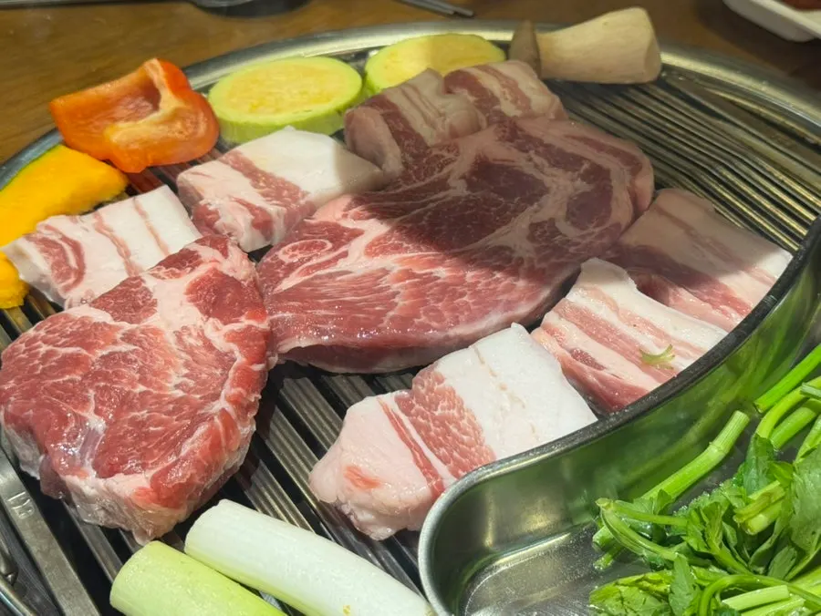Kirin draft beer alongside pork belly on the grill