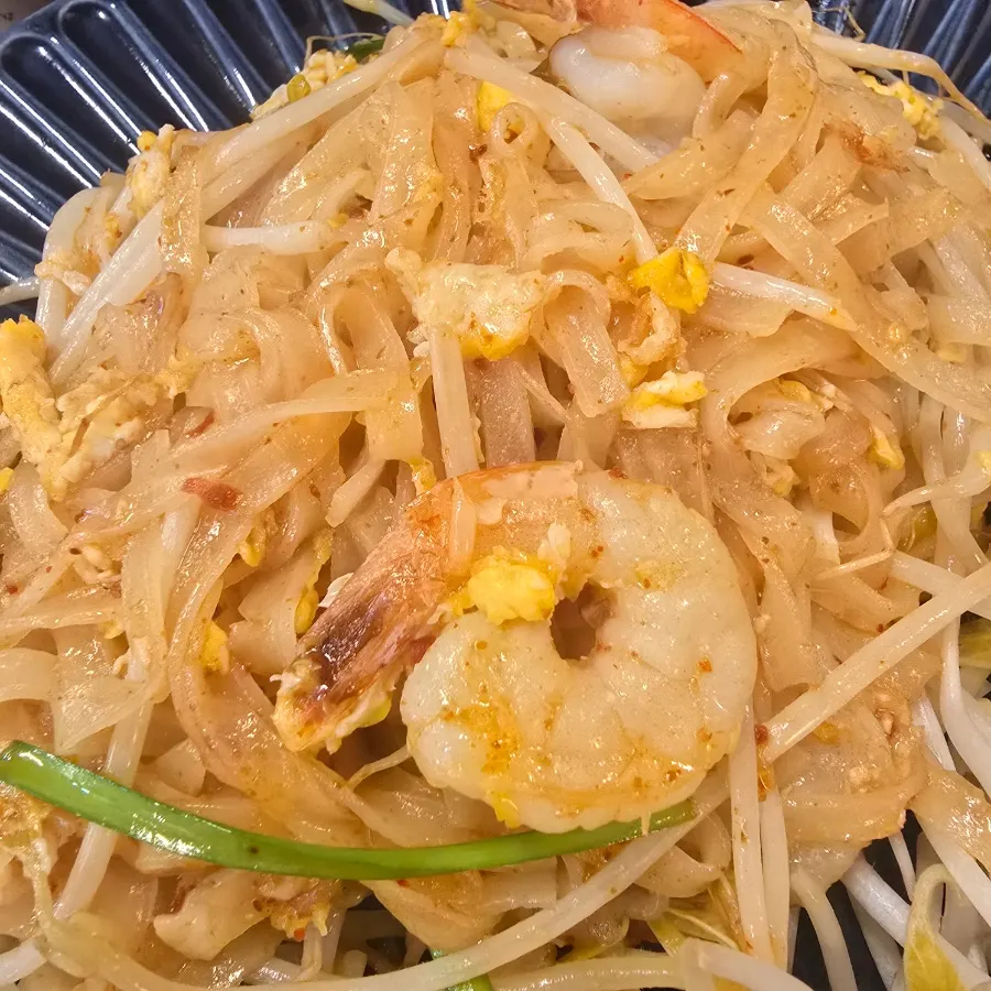 Close-up of large shrimp on top of the pad thai