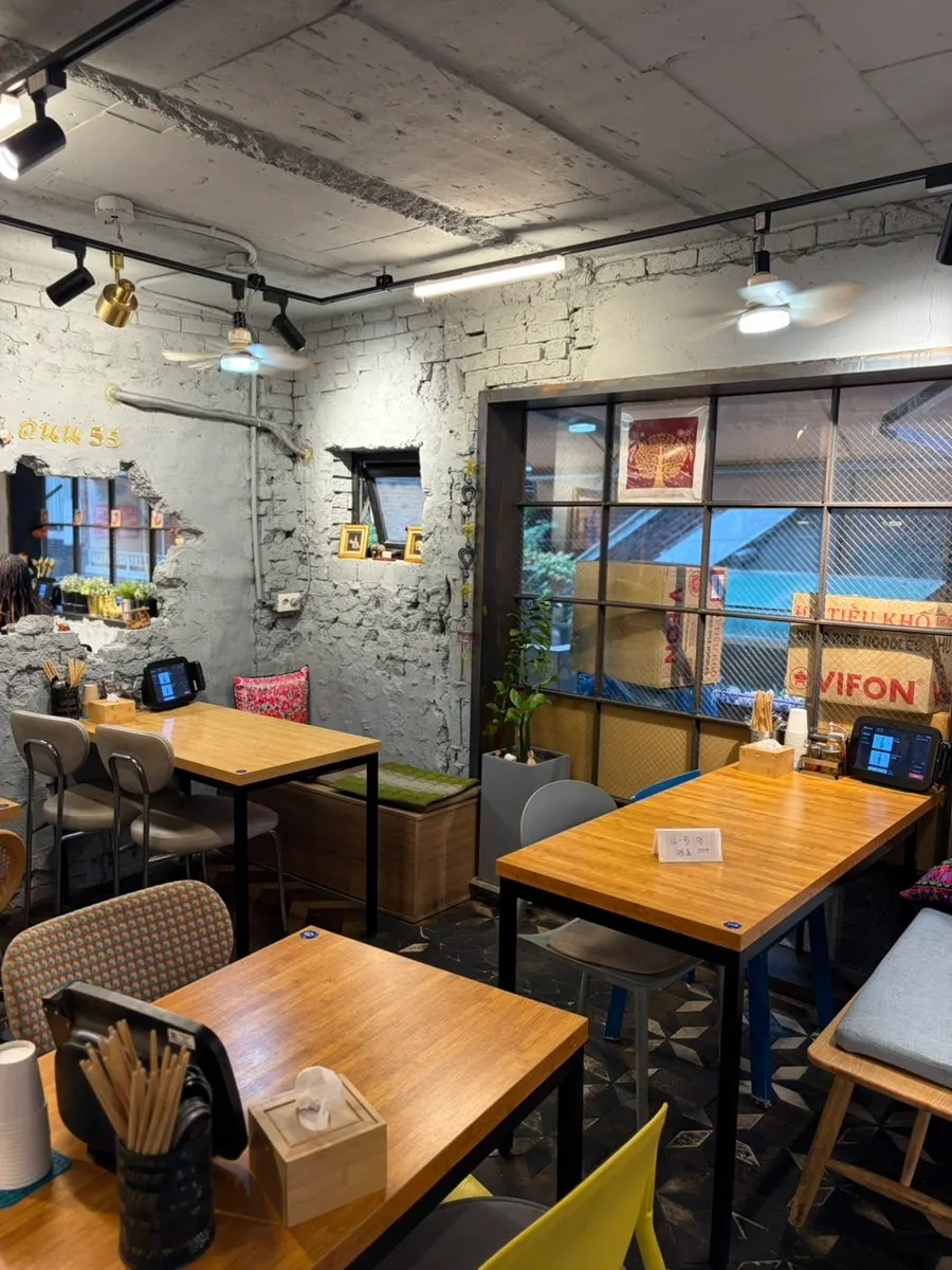 Interior of Thanon55 with antique decor and colorful chairs