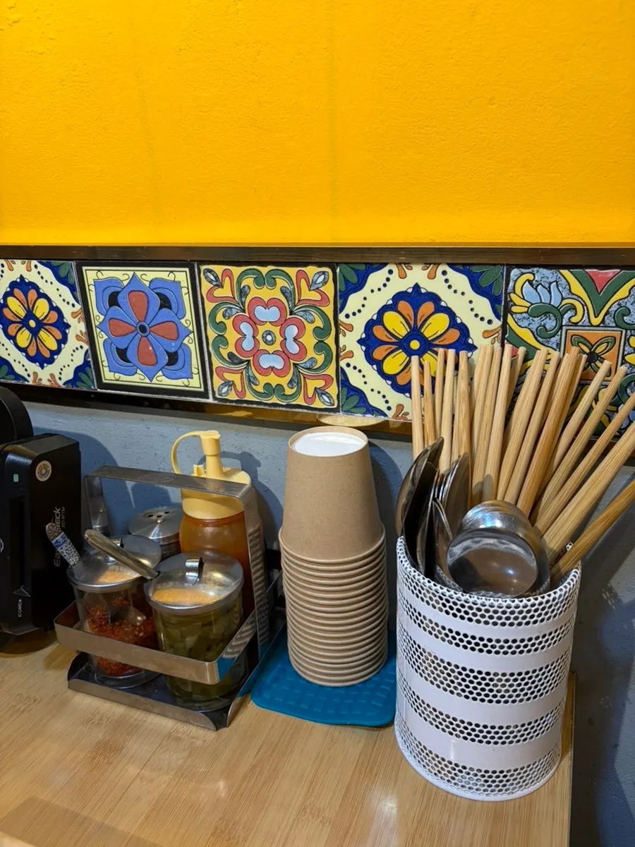 Thai seasoning containers on a table at Thanon55