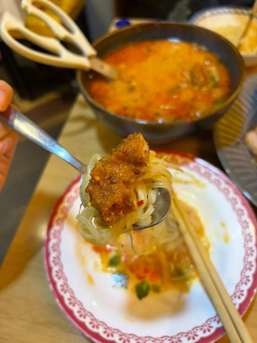 Pho topped with bean sprouts and fried tripe