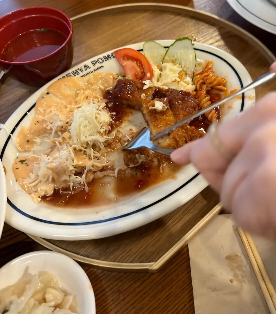 Cross-section of pork katsu over seasoned cabbage