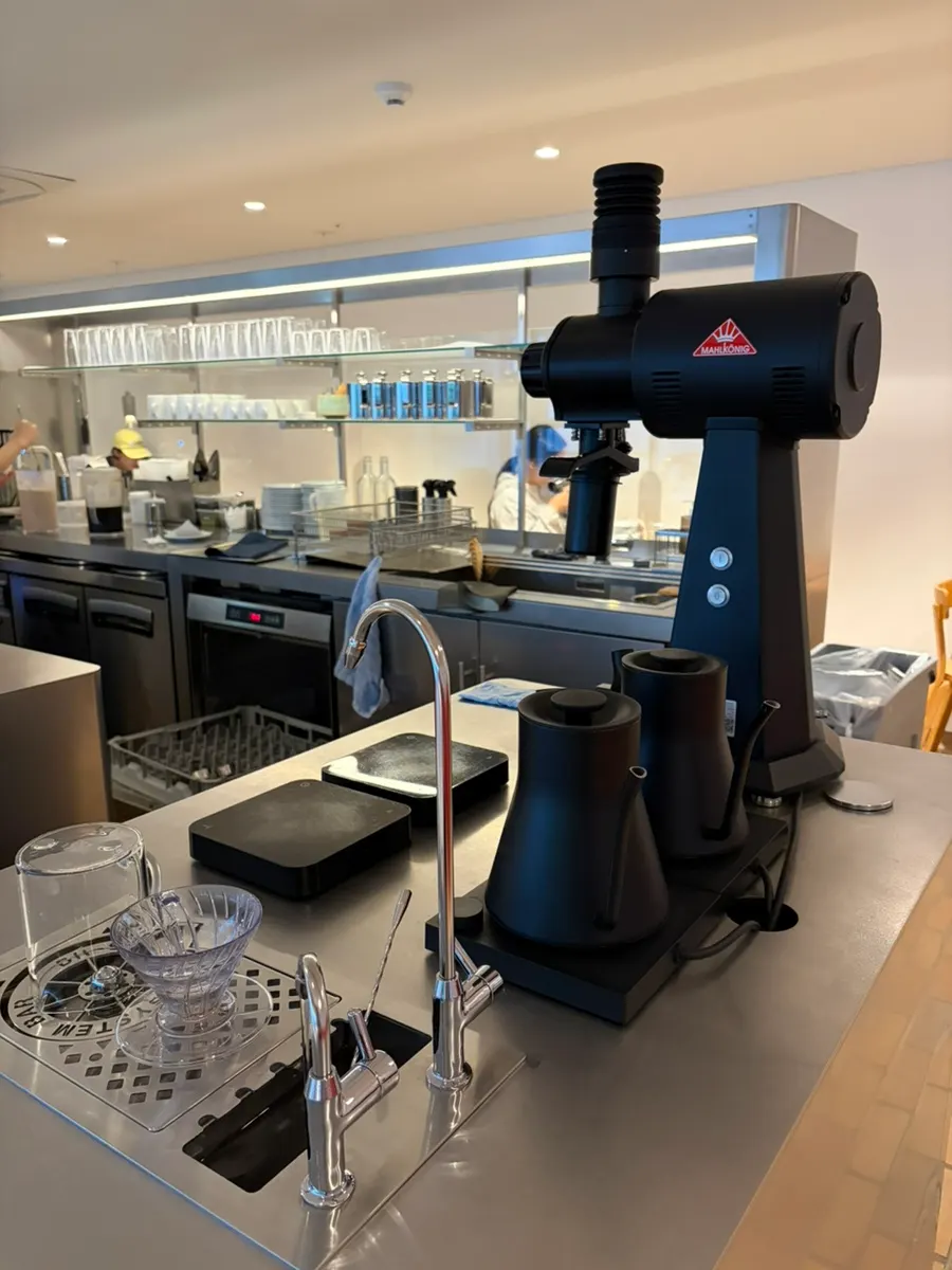 The coffee machine area with a barista at work