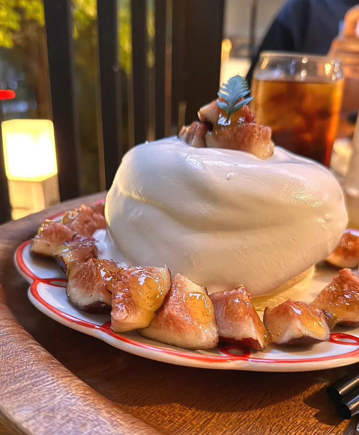 Close-up of cream cascading down the fig soufflé