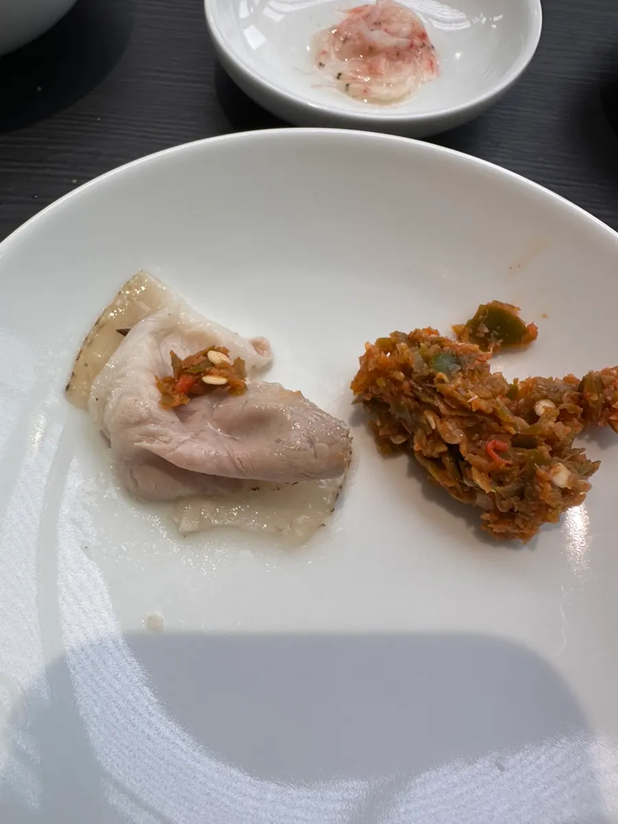 Side dishes and chili sauce served with the gomtang