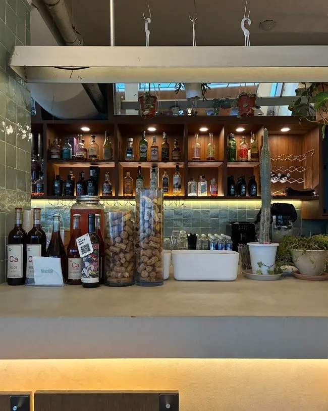 Wine bar space with plants and alcohol