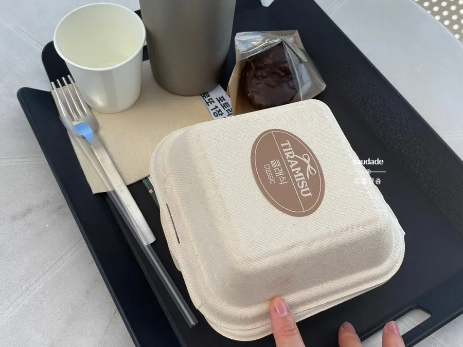 Tiramisu packed in a takeaway paper box