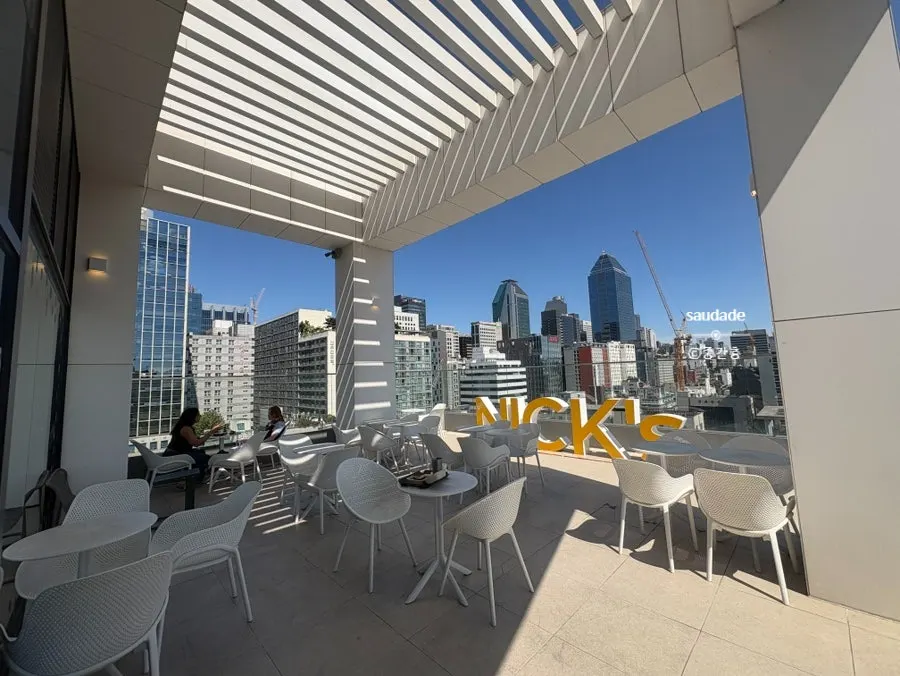 Rooftop terrace seating at Selected Nicks with a Gangnam building view