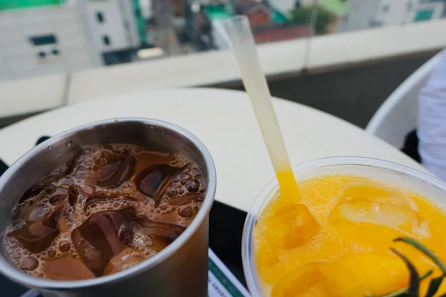 Two glasses of cold brew latte and mango juice