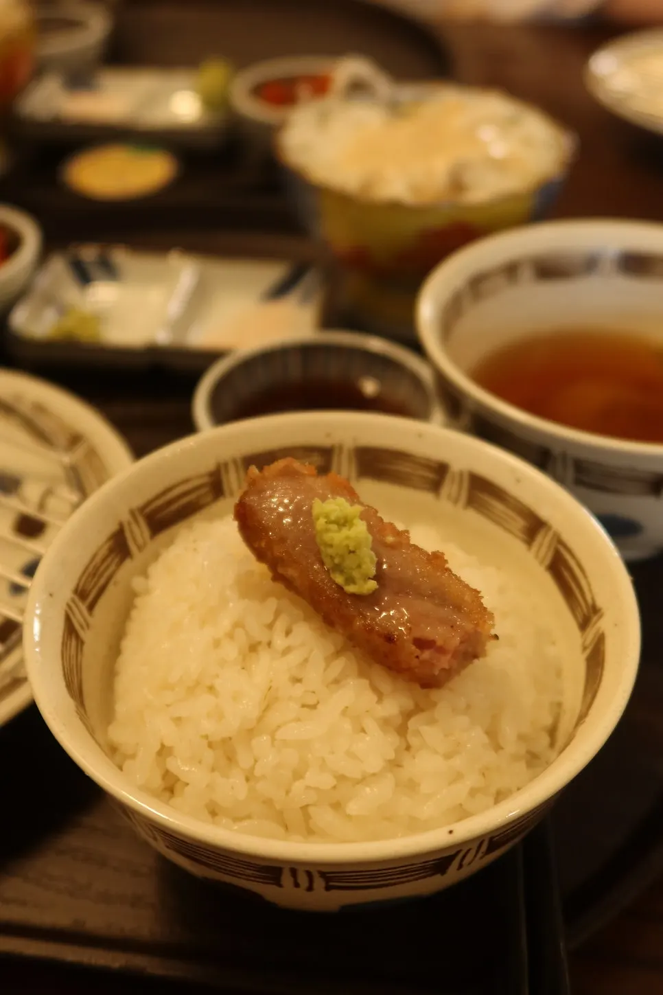 A piece of gyukatsu with salt and wasabi