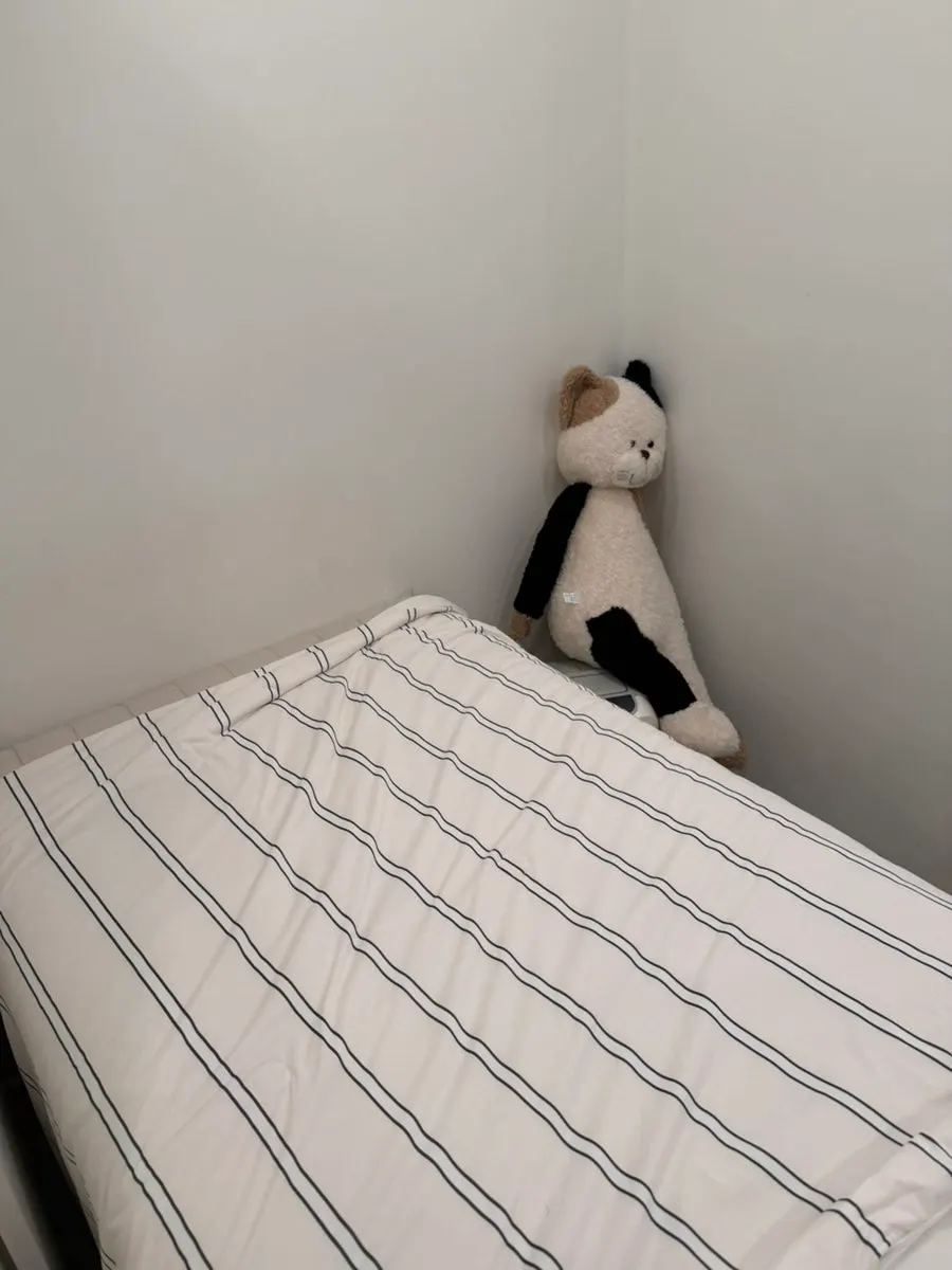 Private treatment room and bed separated by curtains