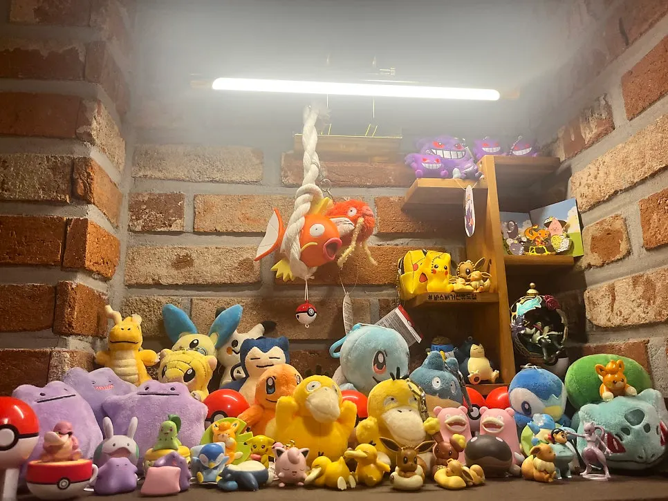 Shelf densely stacked with Pokémon dolls by type