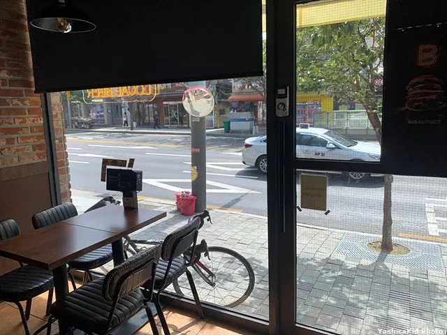 Seat with a view of the entrance and parked bicycle