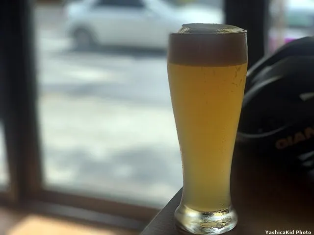 Cloudy draft beer ordered in a small glass